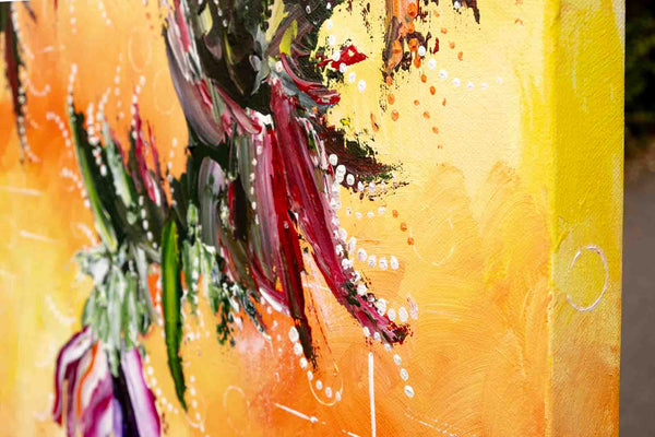 Detailed close-up of the abstract painting called 'The Shimmering Glade', by Annette Price. It depicts warm colours in yellows and oranges with the suggestion of a purple flower. The edge of the stretched canvas is in the foreground and shows how the painting continues on the edges of the canvas.
