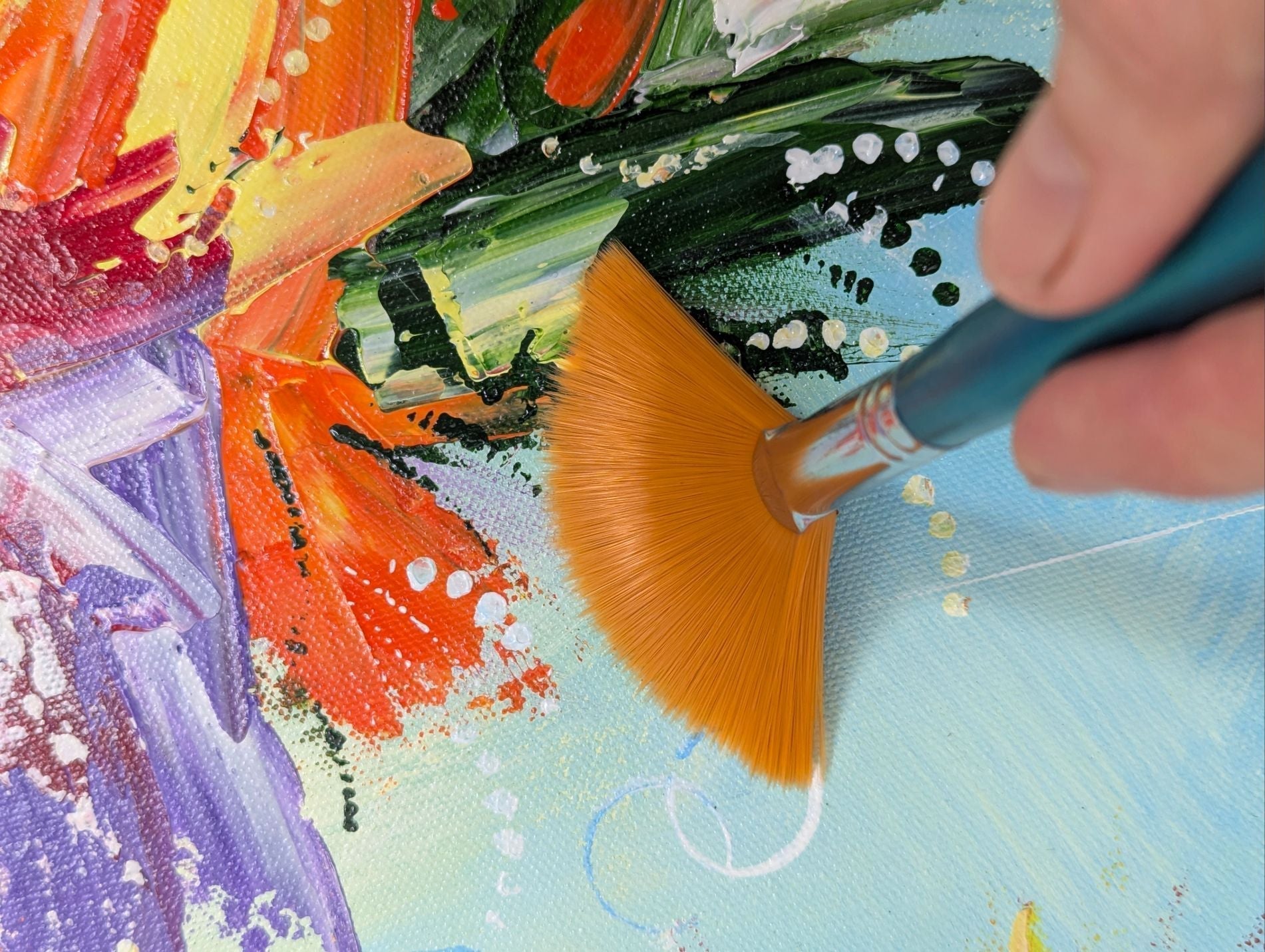 Removing dust from a painting using an artist's fan brush